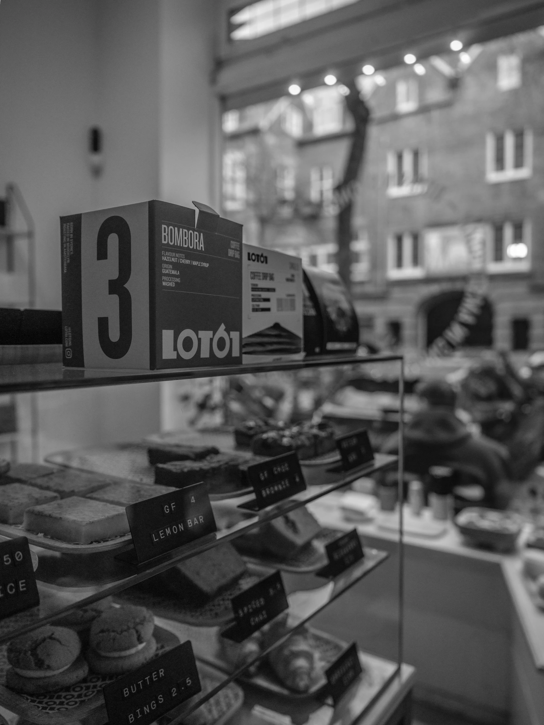 Pastries, coffee bags, and baked treats displayed inside a cafe