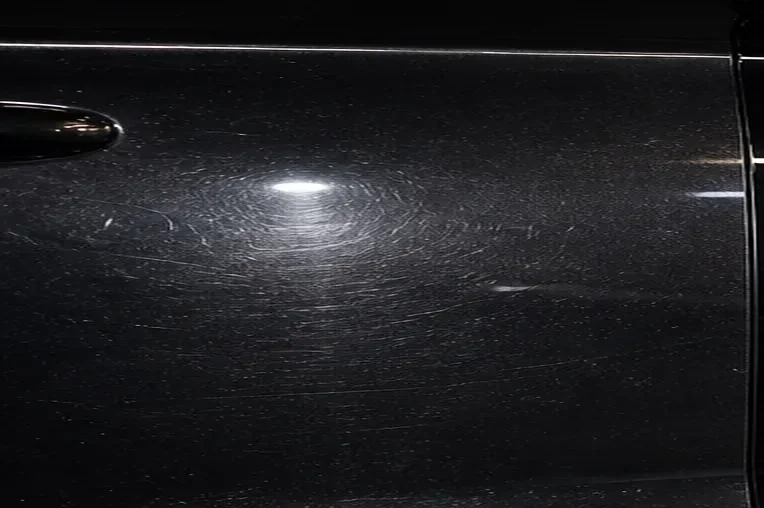 Fictional paint surface with visible swirl marks before correction